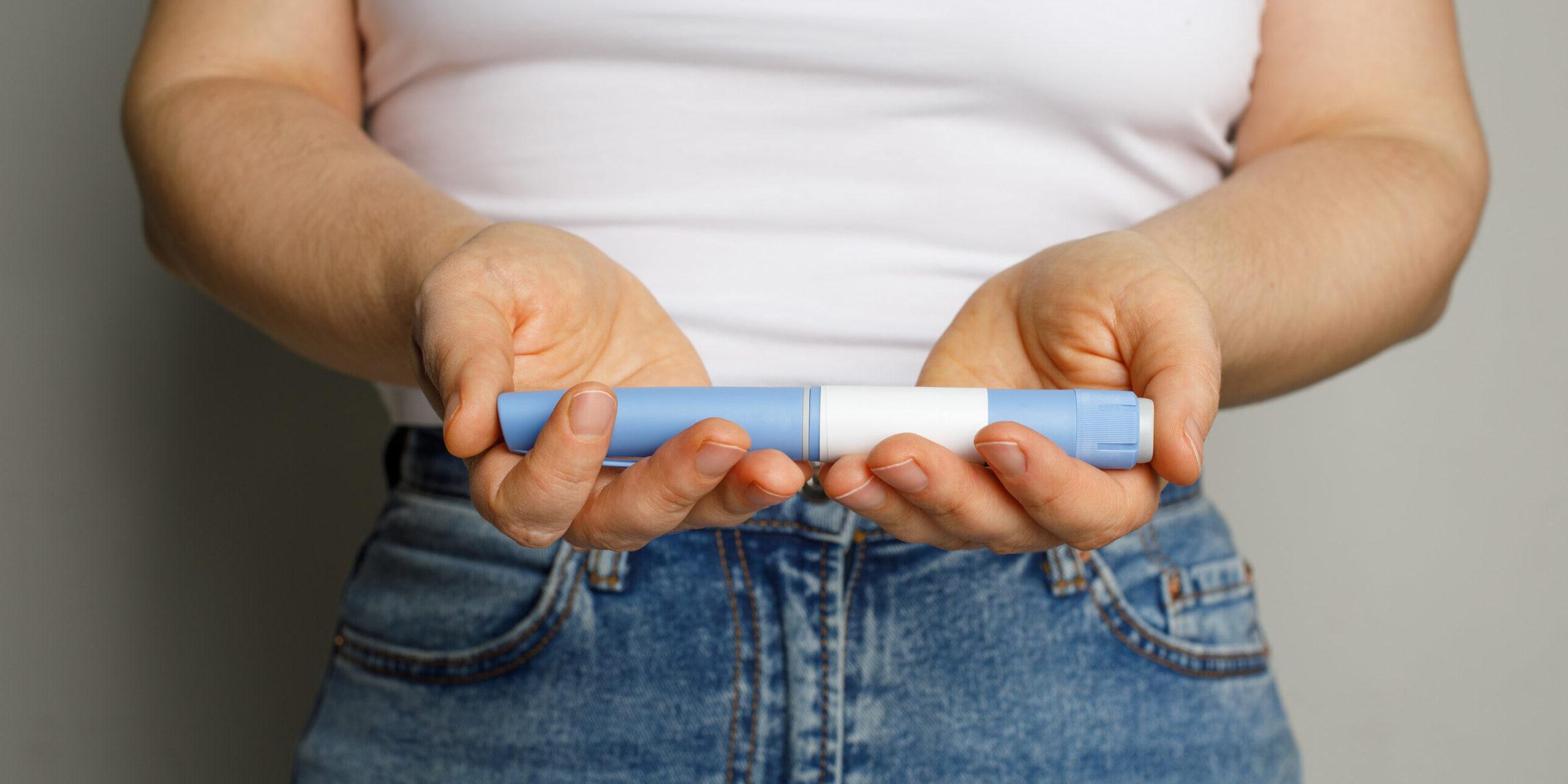 A patient holding their Ozempic weight loss medication 